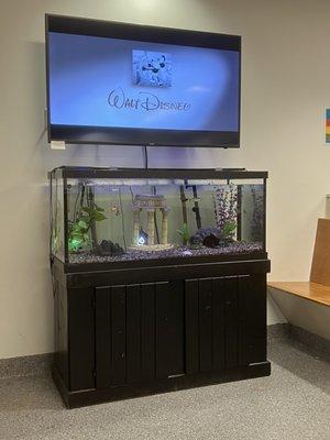 Tv and fish tank in waiting room.