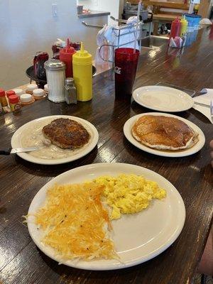 Country fried steak and eggs, hash browns, a giant pancake and an extra plate so we could split it!