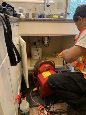 Jose using his machine working on a Kitchen Sink!