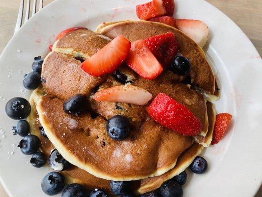 Mouth watering buttermilk pancakes with fresh strawberries and blueberries! YUM!!!