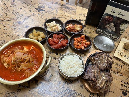 Kimchi Tofu and Pork soup  , Short Ribs and sides of different kimchi styles and Rice.