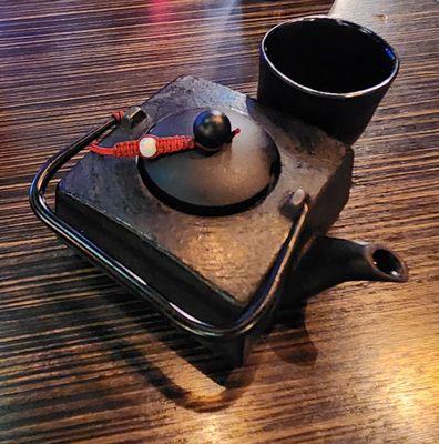 Iron teapot of green tea.