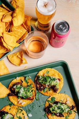 Plenty of beer, wine, and non-alcoholic options available. (shown: vegan maitake mushroom tacos, house-made corn chips)