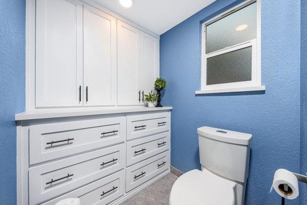 Palmdale Master Bathroom full remodel. Custom built-in dresser with upper storage cabinet. Shaker style painted white.