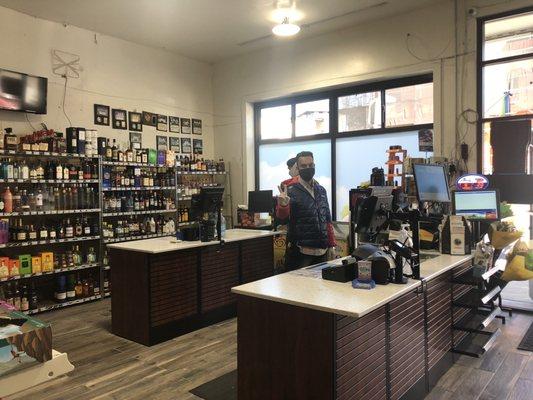 Friendly cashier, new checkout counter at the Colusa Market. A decent alcohol selection in the background.