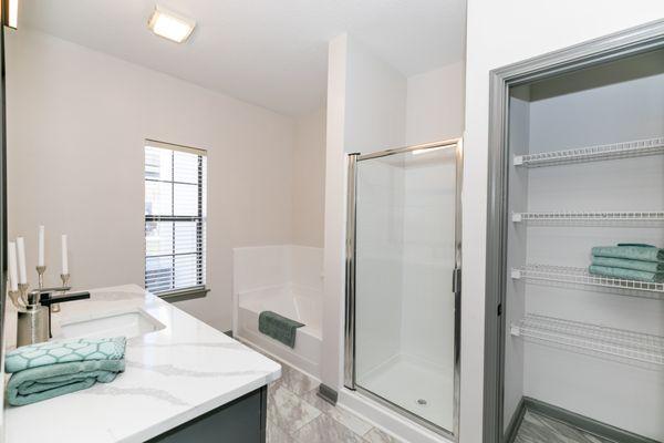 Renovated bathroom with glass shower and tub