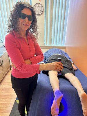 Dr. Allie using Cold Laser Therapy to treat a patient.