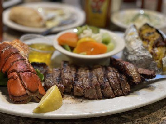 8 oz NY steak & 4 oz lobster tail with a loaded baked potato and veggies on the side. Amazing!