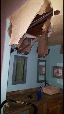 Bathroom ceiling damage due to leaking Polybutylene pipes.