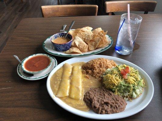 2 cheese enchiladas, bean and cheese tostada with guacamole, rice, beans, salsa, queso and chips.