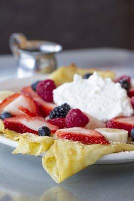 Fresh fruit crepes topped with homemade whipped cream and strawberry syrup!