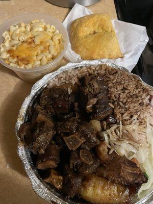 Mac and Cheese, spicy beef patty, large order of oxtail, comes with rice and peas, cabbage and sweet plantains