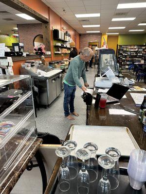 Barefoot employee/owner in food prep area