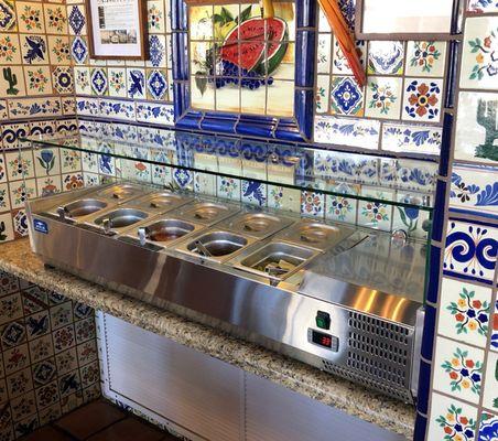 Toppings Bar with Hot, Medium, and Mild Salsas, Jalapenos, and Limes