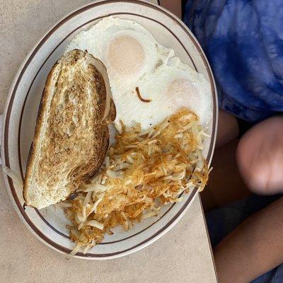 Over easy eggs, hash browns and Italian toast