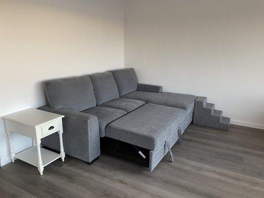 New side table and sectional with cool ottoman pullout.