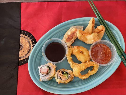 My takeout sampler plate: Gyoza, Crab Rangoon, Calamari, Las Vegas Roll, and Crunchy Roll with gyoza and Rangoon sauce.