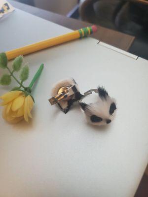 2 raccoon rings, tiny plastic flower, pencil for scale