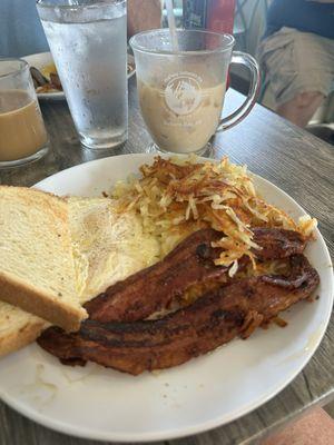 Classic breakfast - Over easy eggs, bacon, hash browns & sourdough toast.