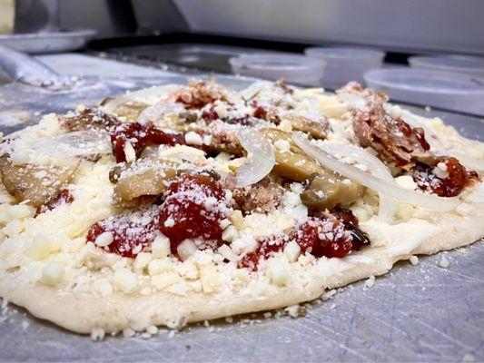 My pizza right b4 it went into the oven. Sausage, mushroom and onion.