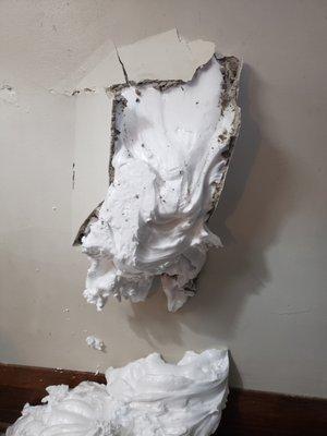 Large hole in living room wall