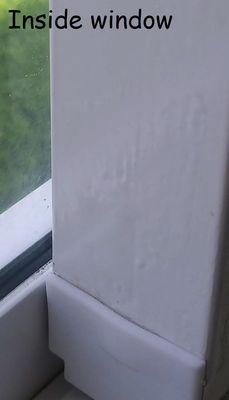 Side of window, inside.