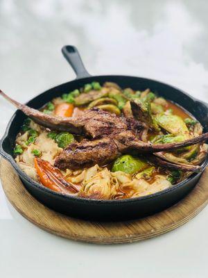 Lamb chops over noodles with clams, peas and Brussels, yummy!