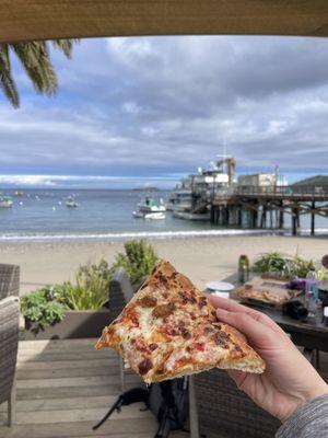 Supreme pizza with a beach view