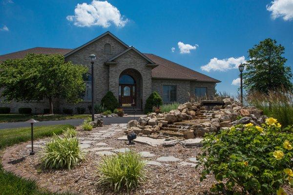 Pondless waterfall surrounded by beautiful landscaping