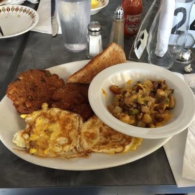 Salmon patties, scrambled eggs and deluxe breakfast potatoes with cheddar cheese, onions, green peppers, etc