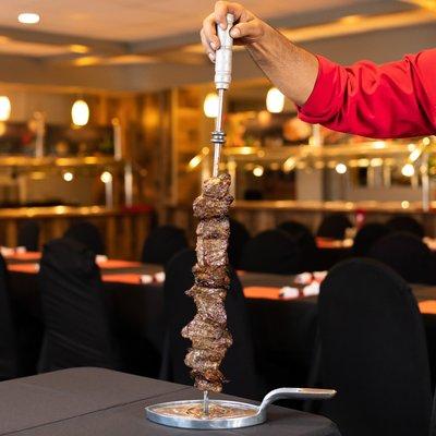 12 different types of meat which are presented on skewers and carved table side. www.cafemineirosteakhouse.com