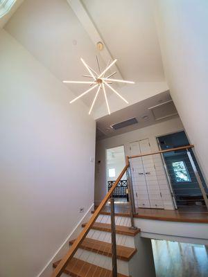 Our team installed this chandelier over a staircase with extra care to the beautiful finish of this home