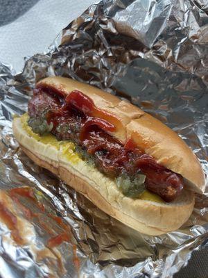 The spicy dog with ketchup mustard and relish