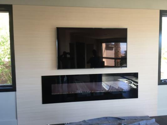 TV above a fireplace.  NO wires shown