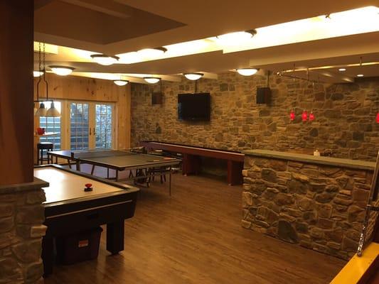 Awesome finished basement with an assortment of different lighting to break up the room