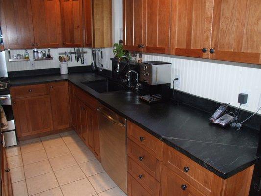 Soapstone counters with integral drain board.