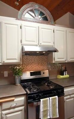 This designer kitchen is highlighted with an overlay done in a metallic finish.  Simple, yet unique and classy!