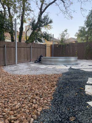 Xeriscape around stock tank pool w/ metal polls for string lights & planters!