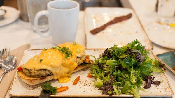 Crab Cake Benedict: Two crab cakes on a ciabatta bun over spinach, poached eggs, sriracha hollandaise sauce and scallions.