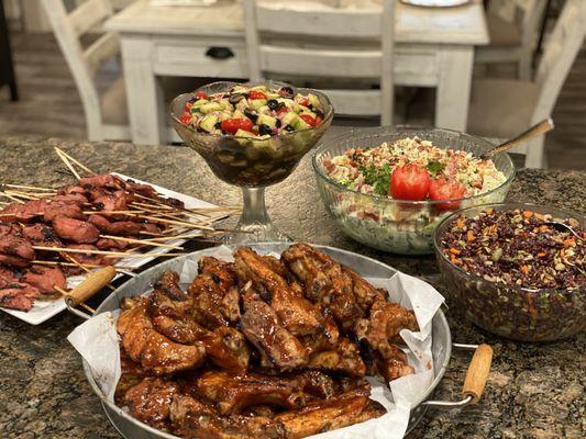 Chicken skewers, BBQ pork ribs, potato salad, black rice salad, cucumber salad