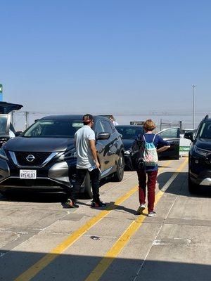 My wife with National Car Rental employee when we returned the Nissan Murano.