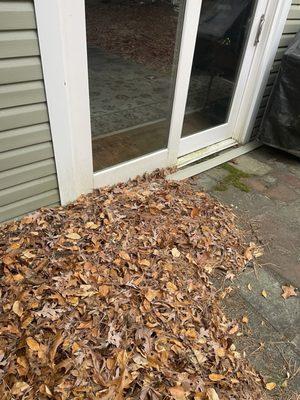 Leafs blown against the house by workers blocking second set of slder doors