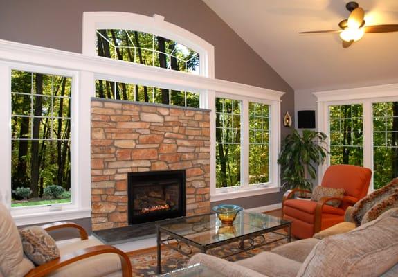 Fairfax County, Virginia; sunroom addition; arched windows; stone fireplace; hardwood floors; panoramic glass; family space