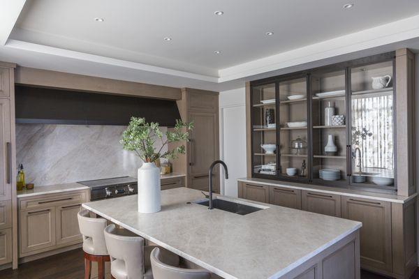 Walnut cabinetry pairs beautifully with leathered white countertops.