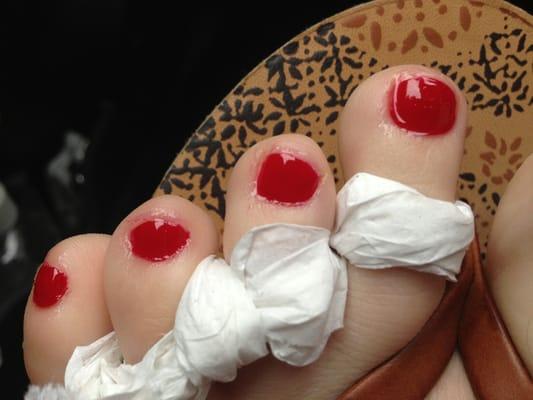 Sloppy pedicure. Cuticles painted and unevenly filed.