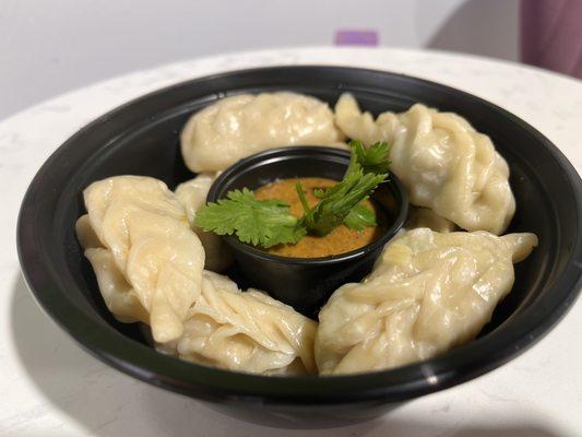 Delicious MOMO: Chicken Dumplings served with unique Spicy Suce (The taste of Himalayas)..