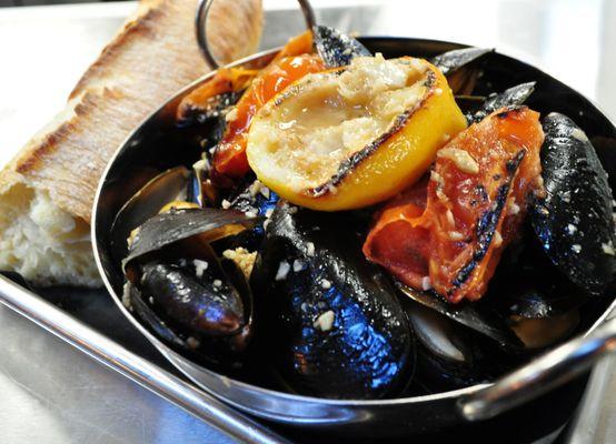 turnt mussels - white wine, charred lemon butter, roasted garlic, blistered tomatoes, baguette.