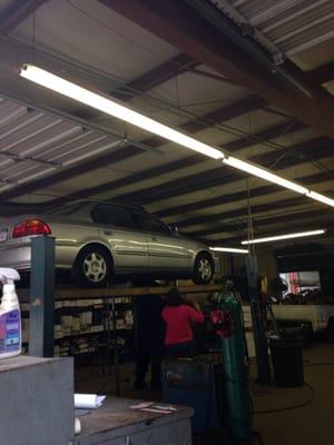 Lady inspecting my blown muffler.