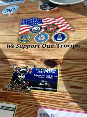 Local business cards laminated on the tables along with proudly supporting our troops!