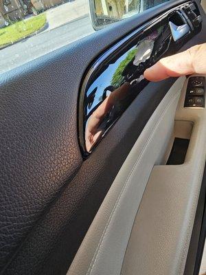 Pointing at the cracks of vinyl on driver door.